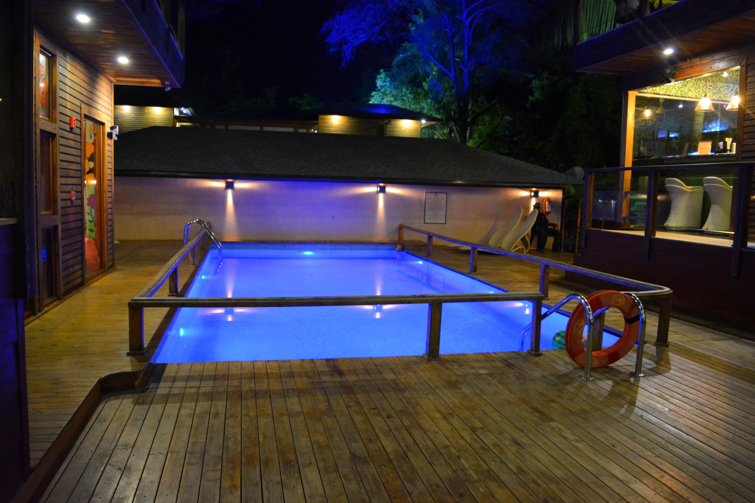 Swimming pool lit with a blue light at night