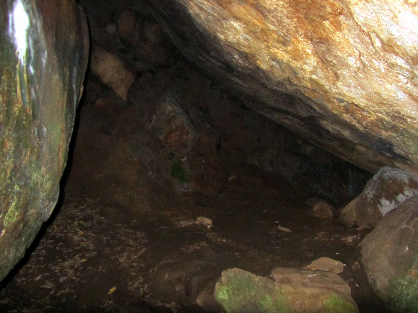 A cave formed by an enclosure of large rocks