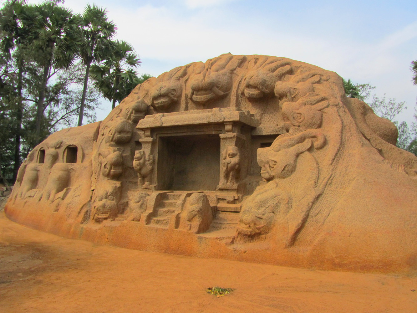 A rock-cut temple known as the Tiger Cave with tiger head carvings at the mouth of the cave