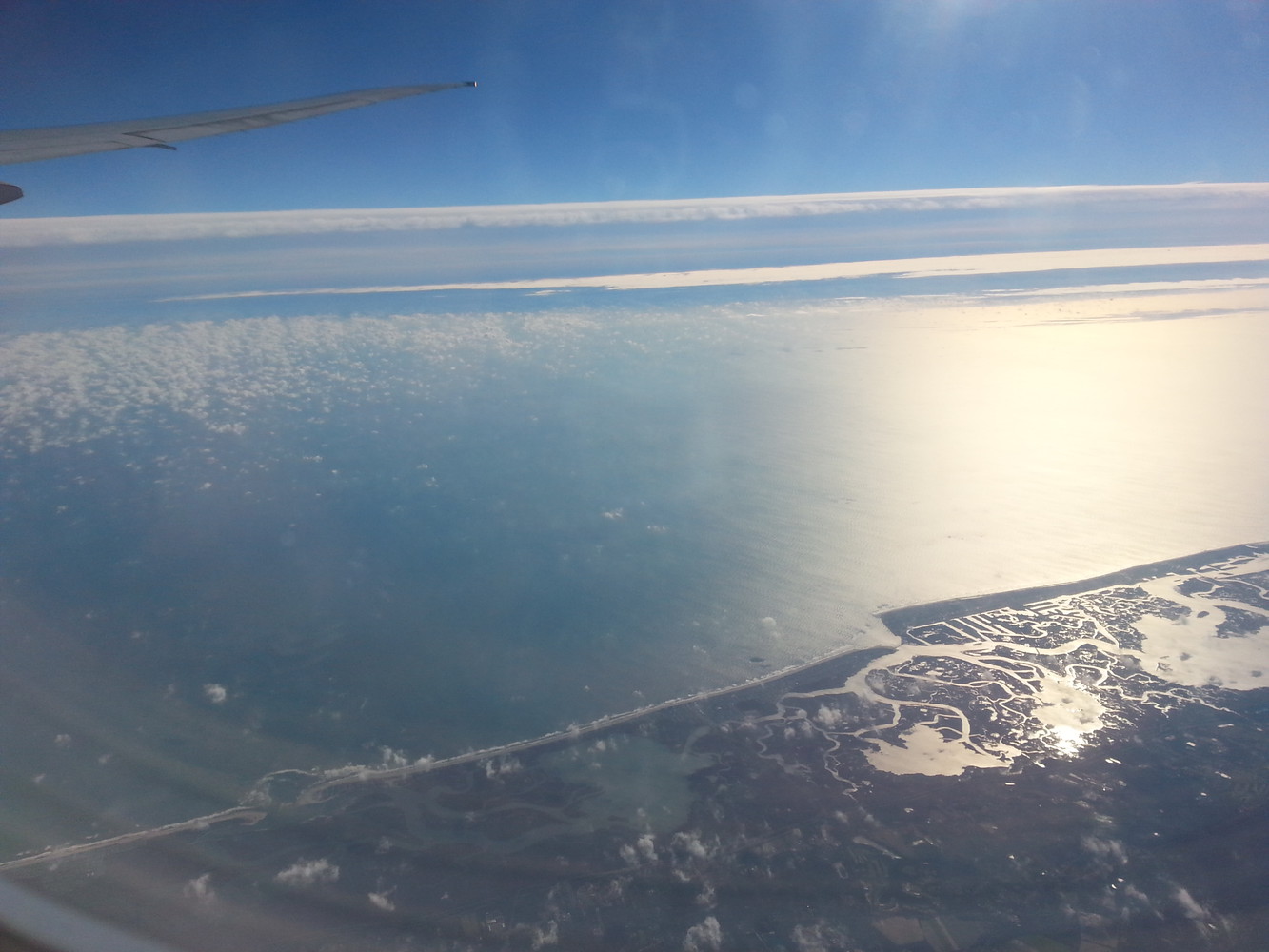 View of basin and sea from the window of an airplane