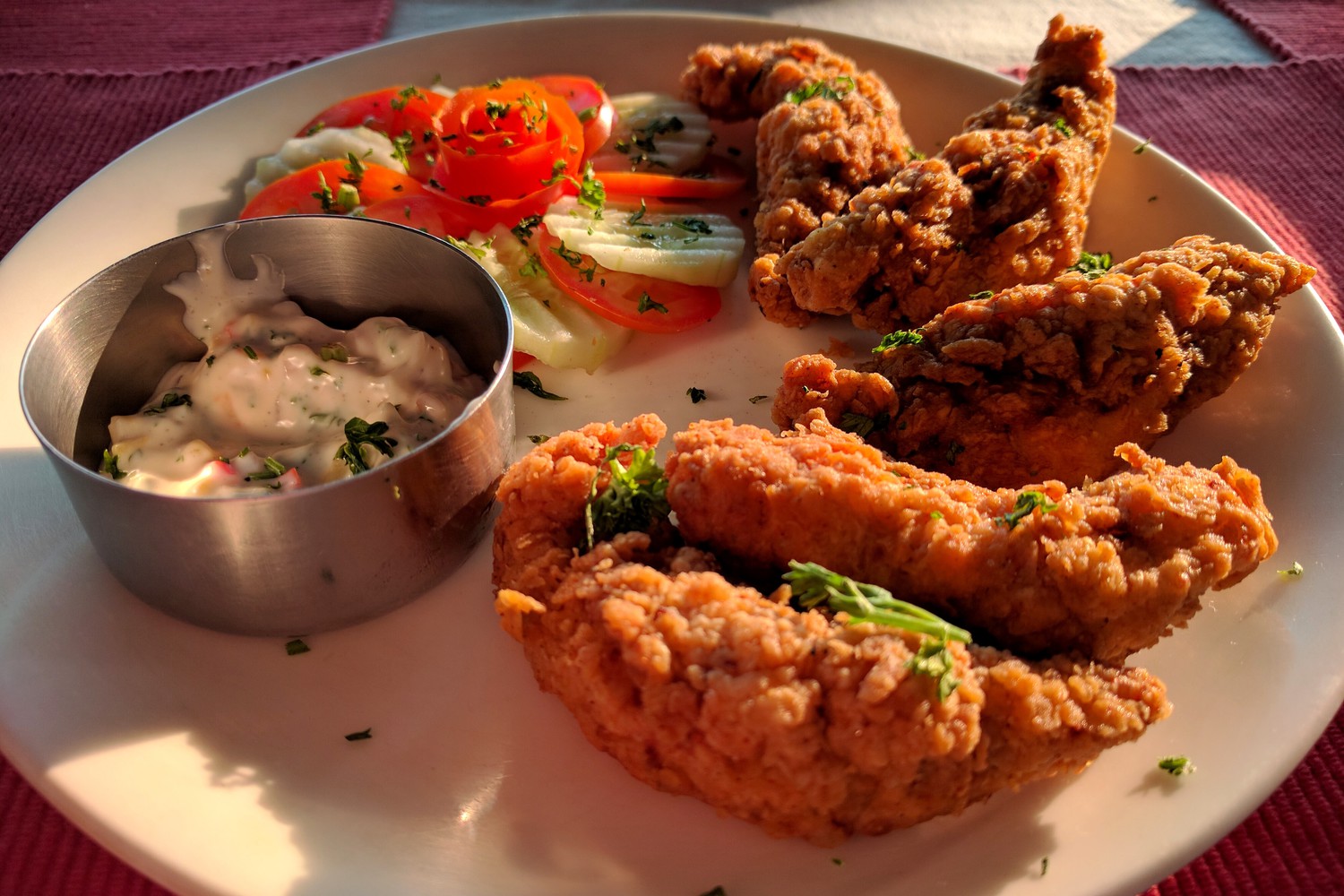 Crispy fried chicken served with sauce and salad